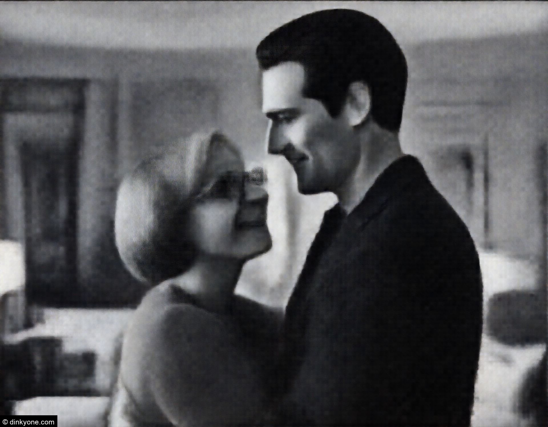 A couple in a boutique hotel room with elegant decor.