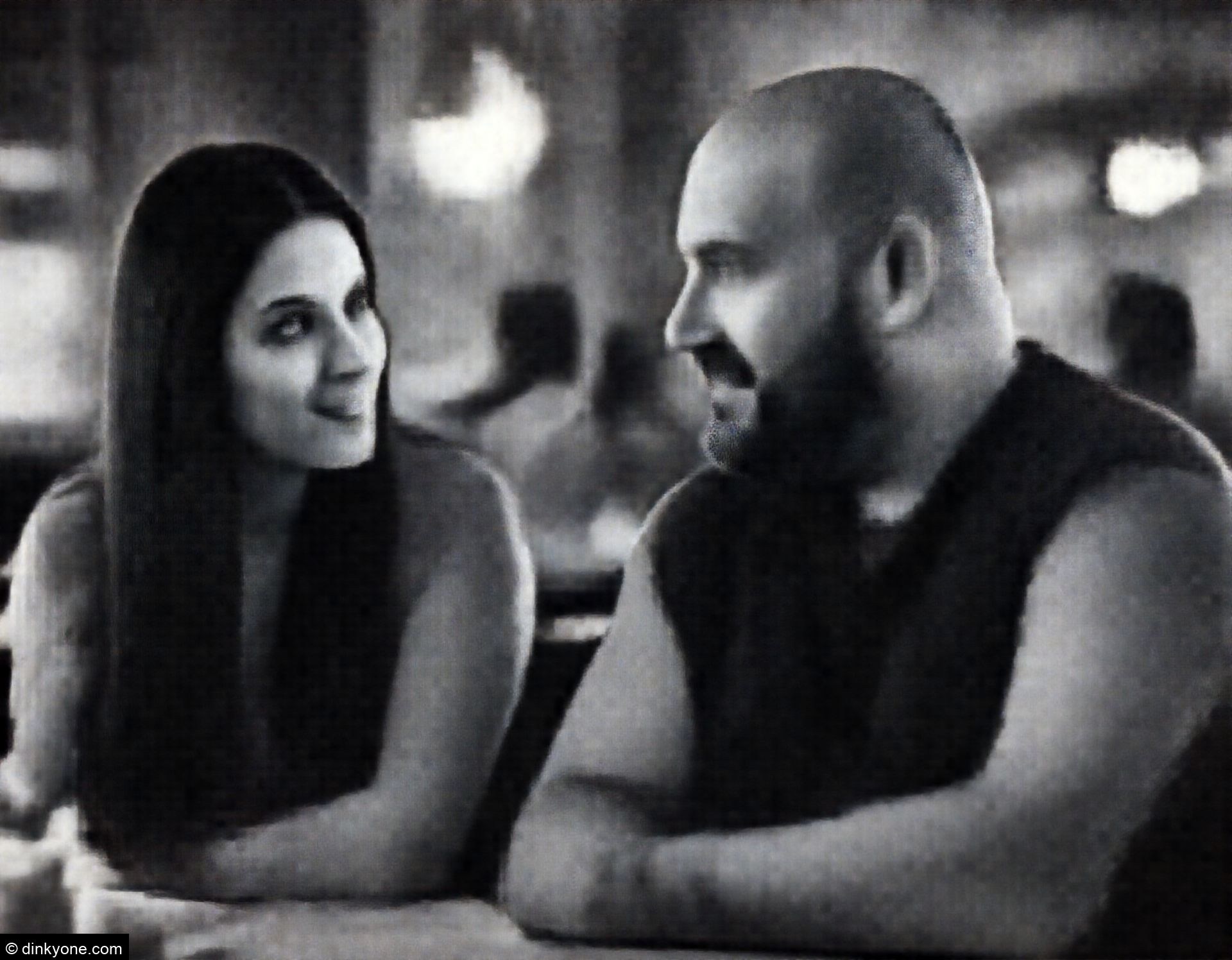 A couple in a casual restaurant with warm lighting.