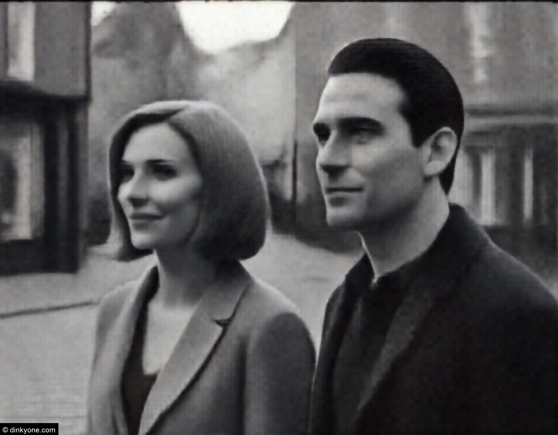 A couple in a historic town centre with cobbled streets.