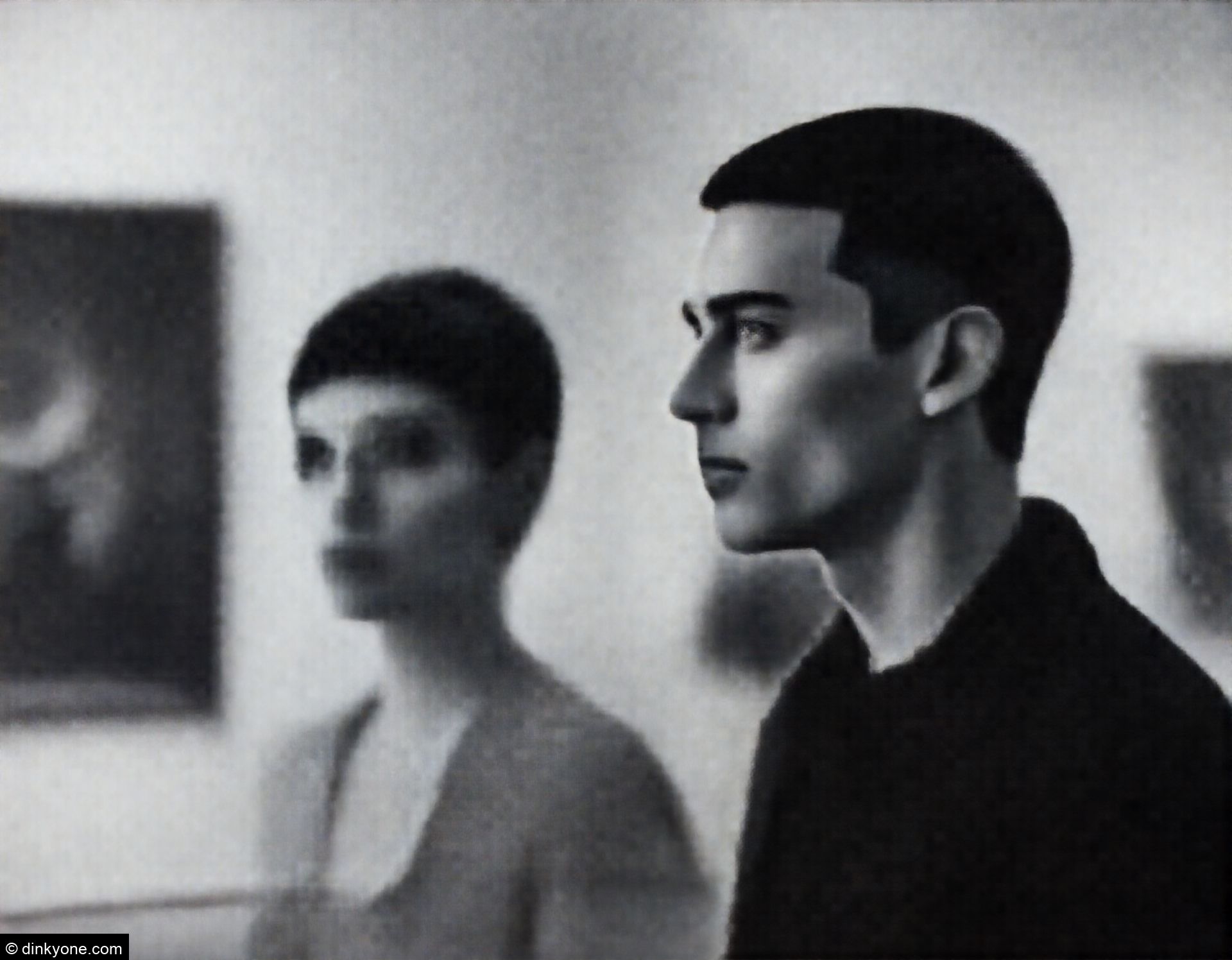 A couple inside an art gallery with contemporary exhibits.