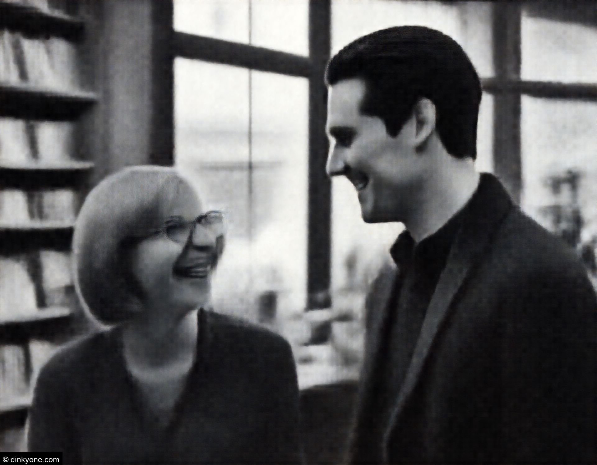 A couple inside an independent bookstore with large windows.