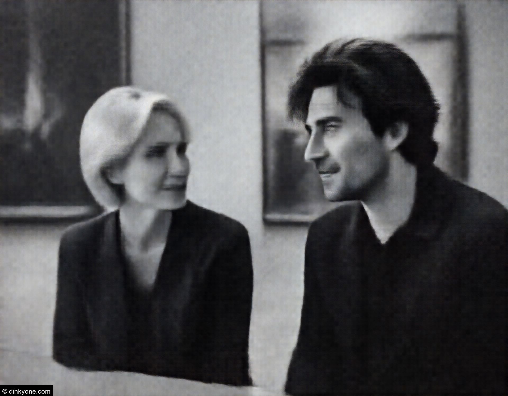 A couple inside a museum with modern art paintings.