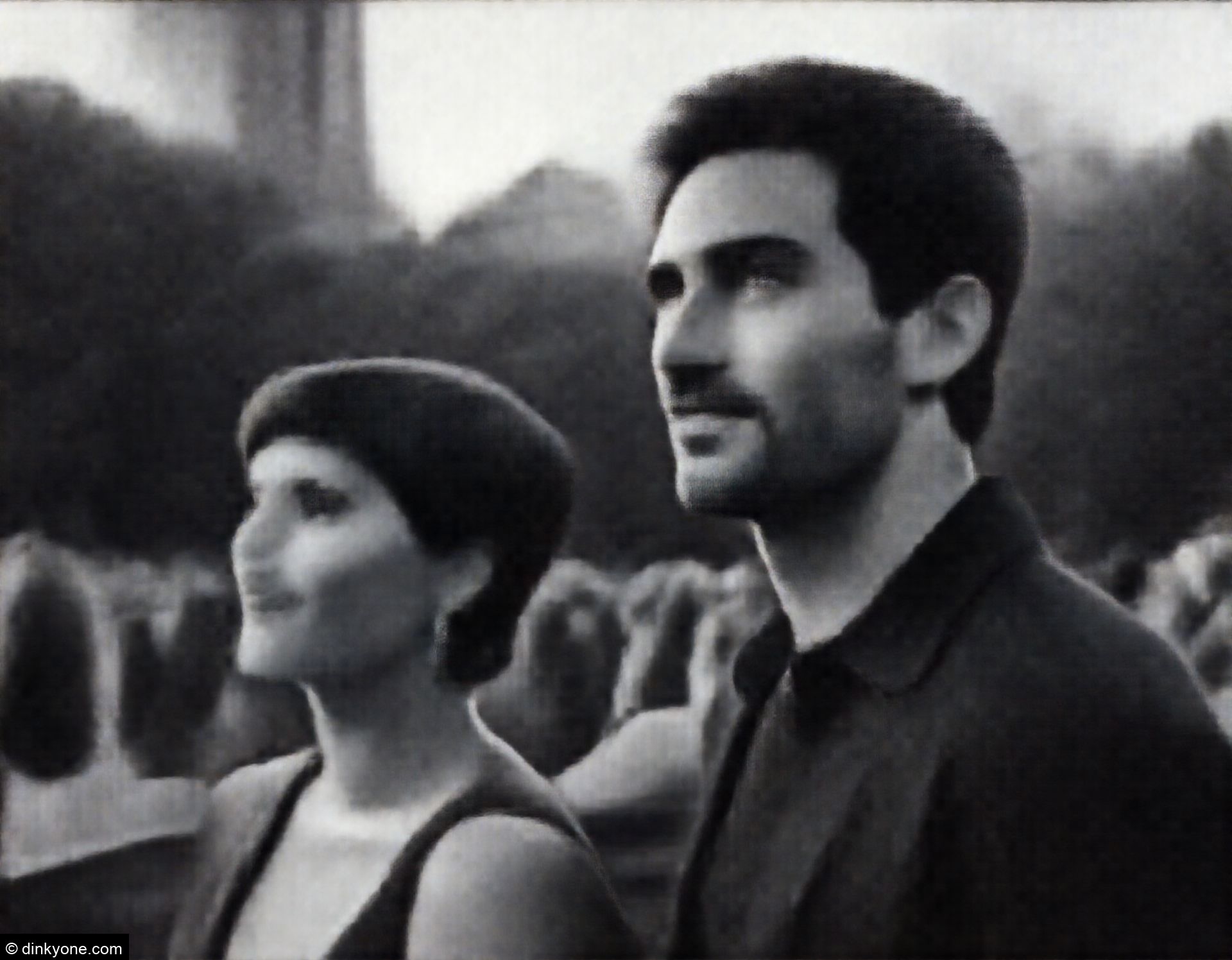 A couple at an open air concert in a city park.