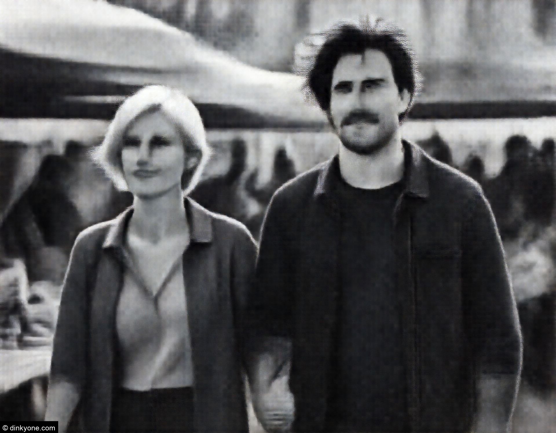 A couple at an outdoor food market with local vendors.