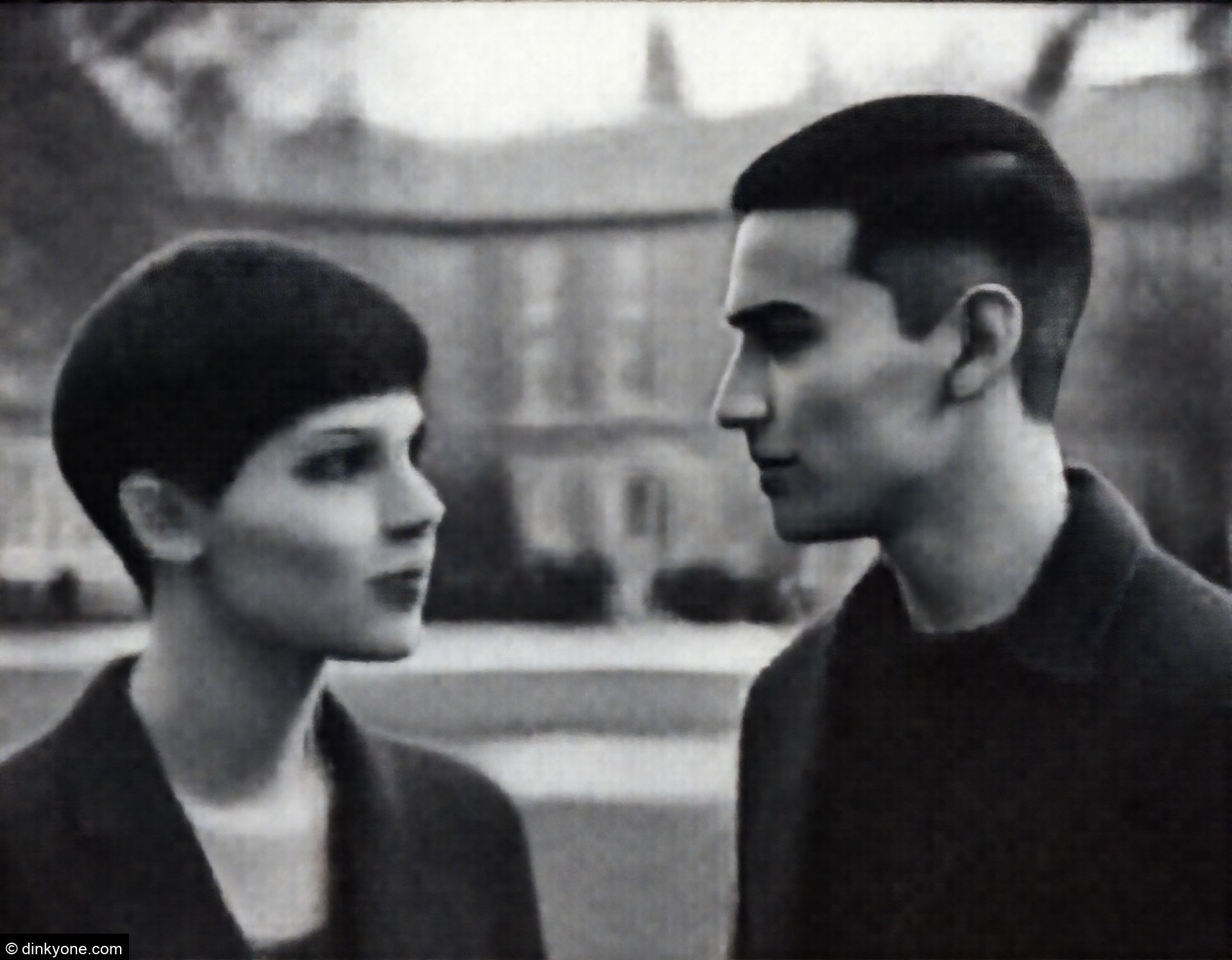 A couple at a university campus with historic buildings.