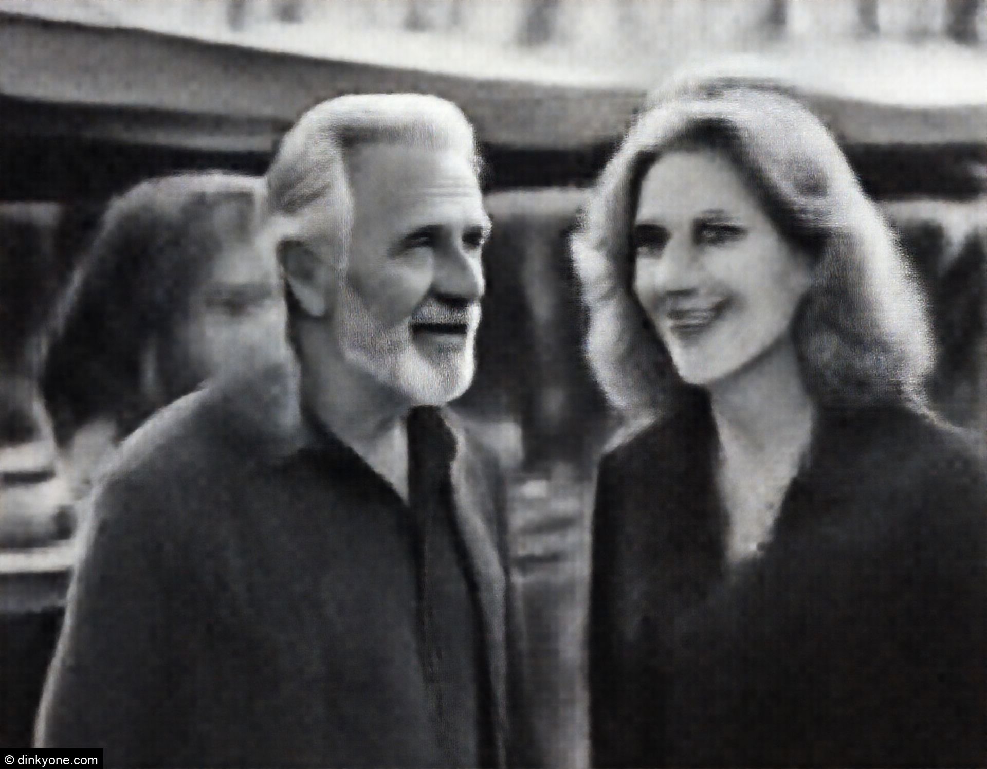 An older couple at an outdoor street food market.