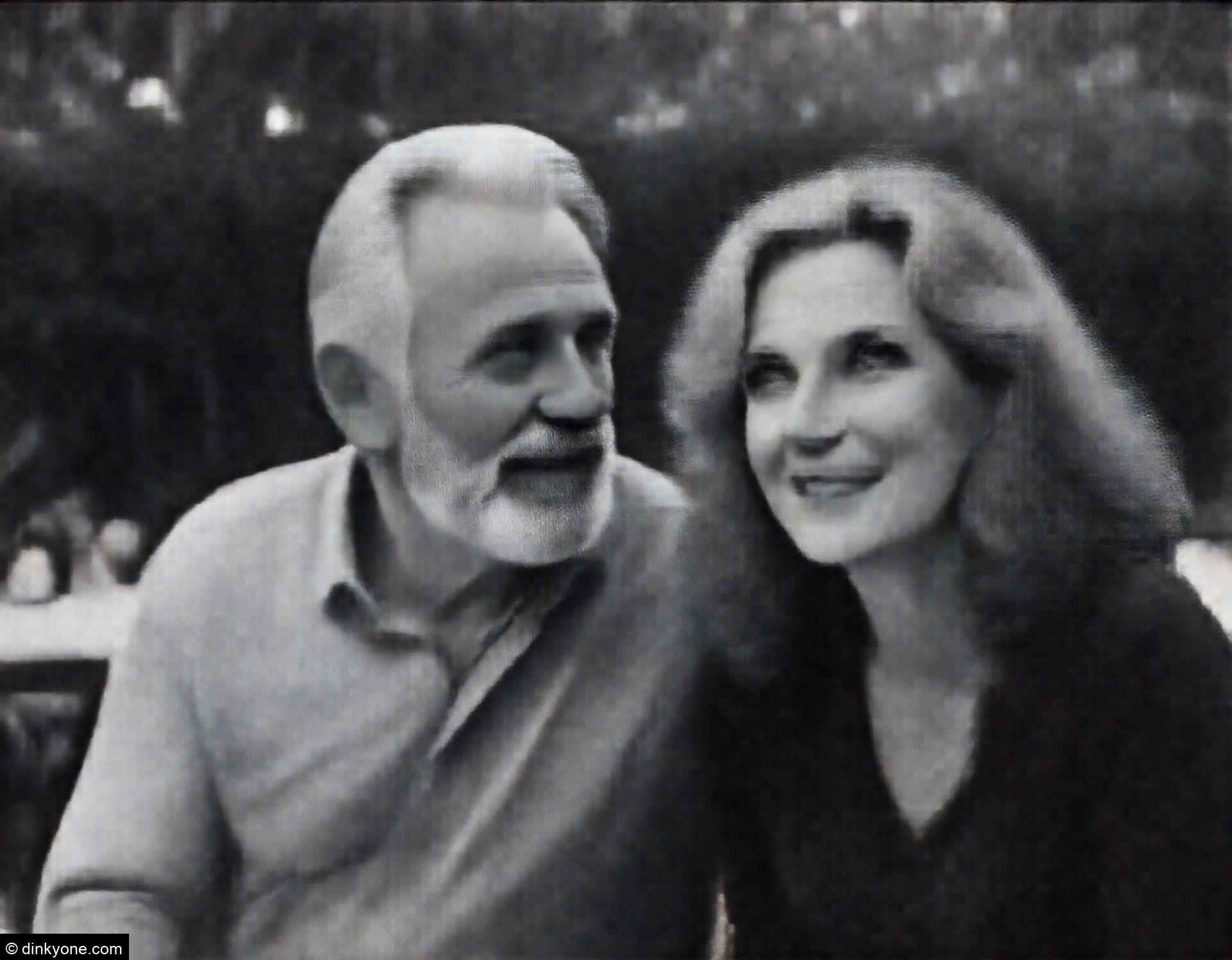 An older couple at a private garden restaurant with fairy lights.