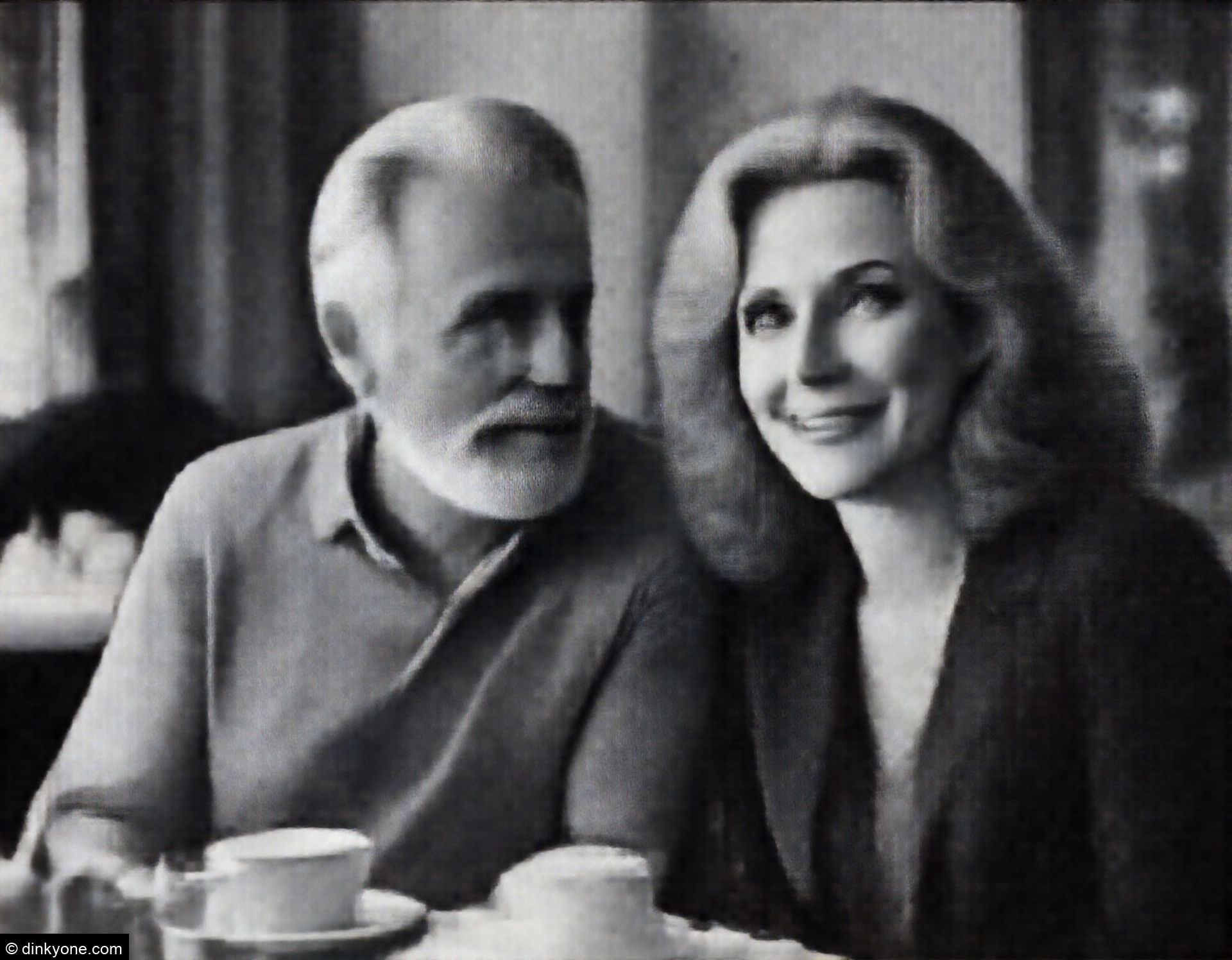 An older couple in a tea room with elegant decor.