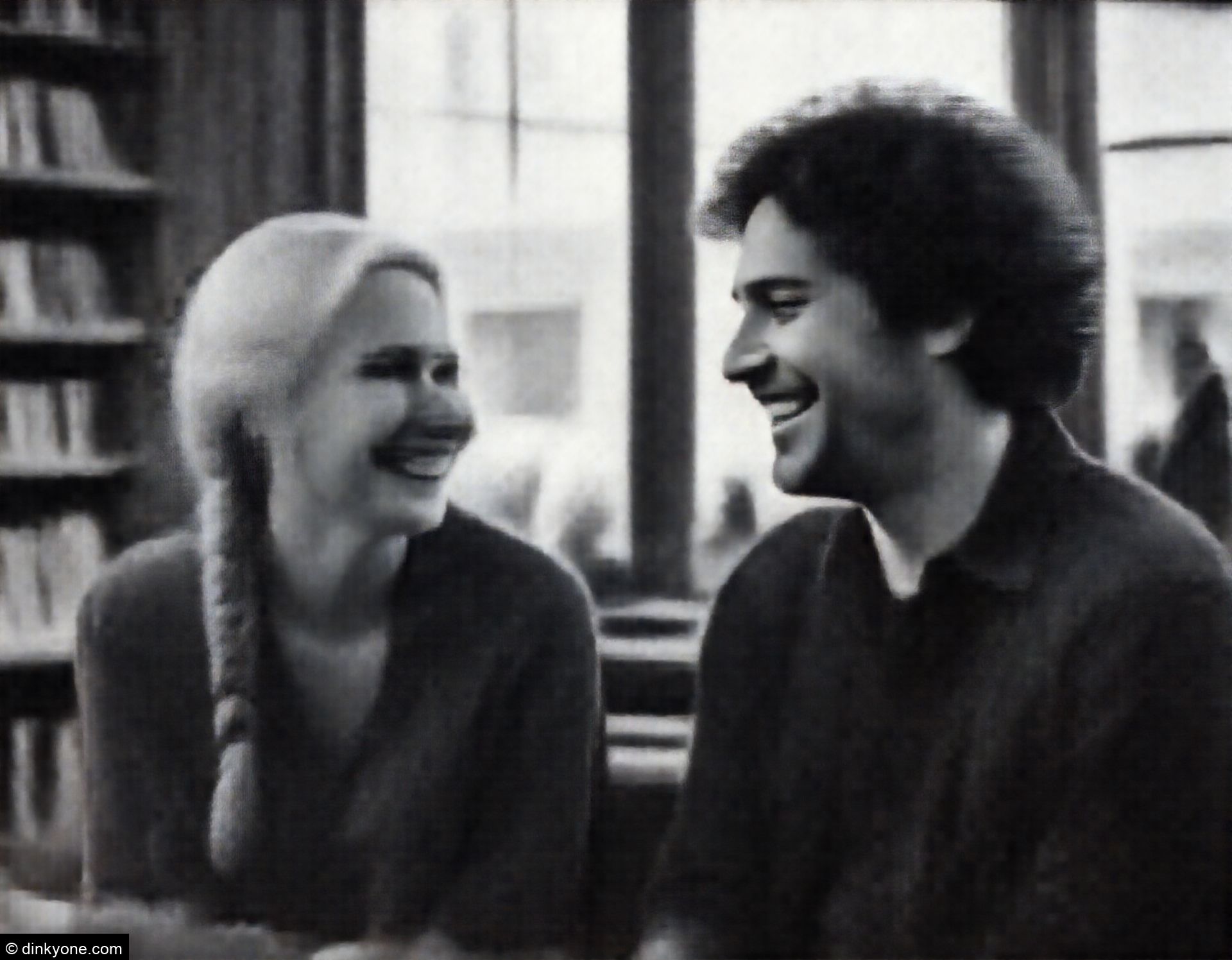 A relaxed couple inside an independent bookstore with large windows.