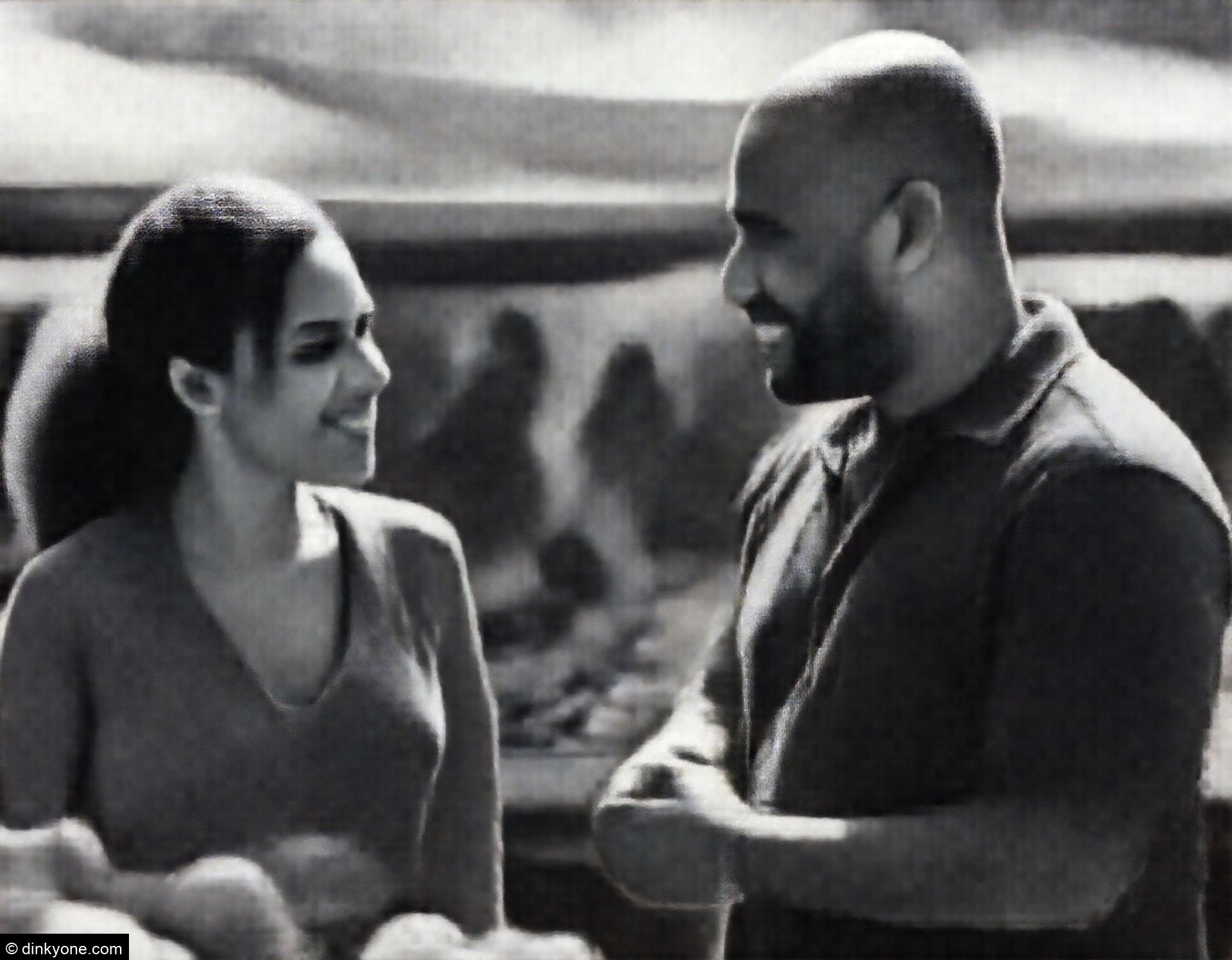 A strong-looking couple at a farmers market on a sunny afternoon.