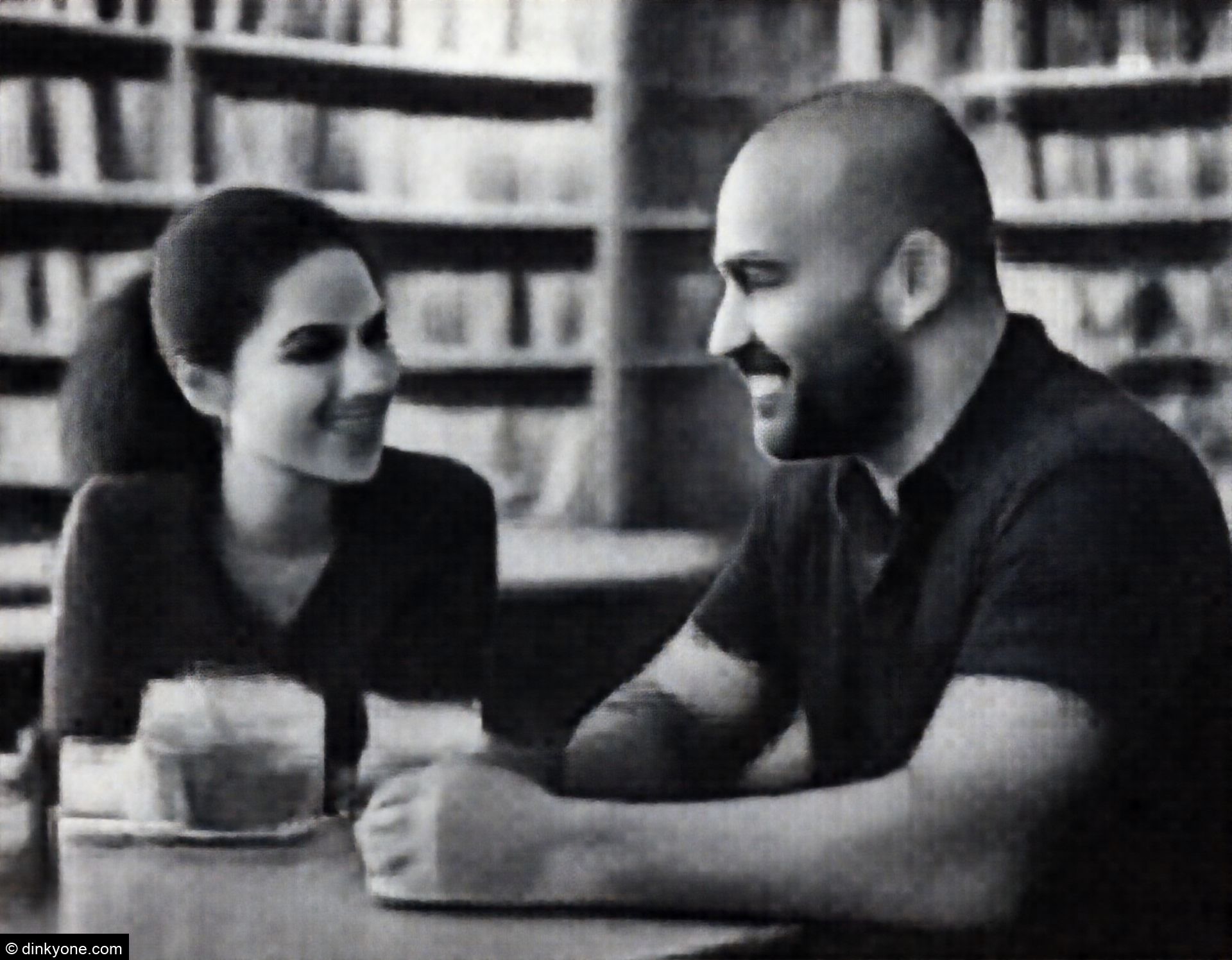 A strong-looking couple inside an independent bookshop cafe.