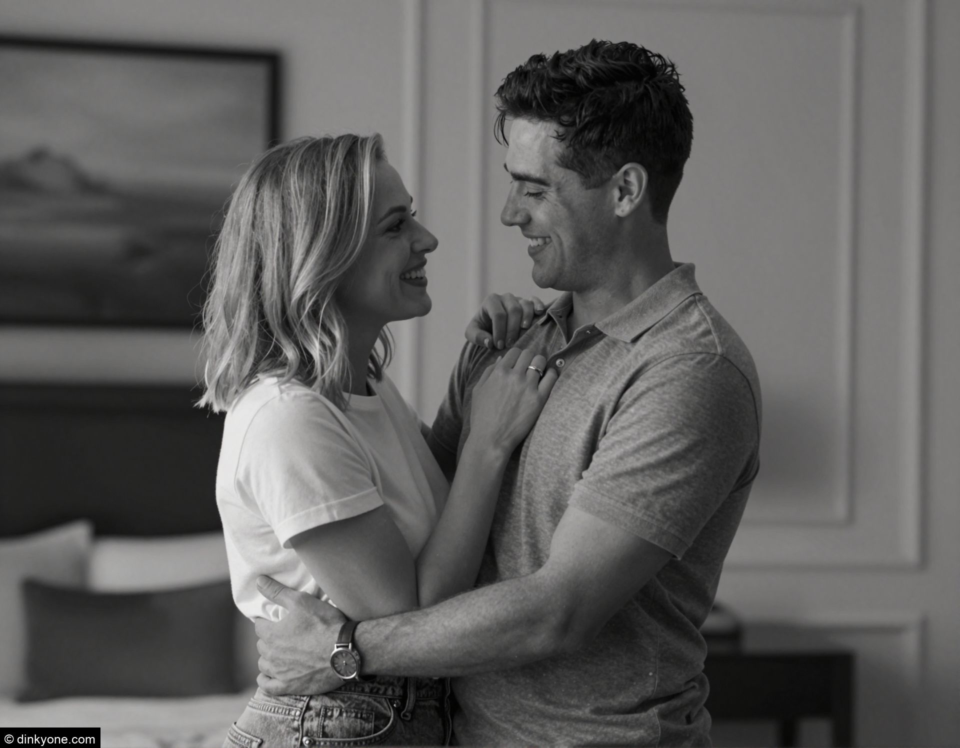 A young couple in a boutique hotel room with elegant decor.