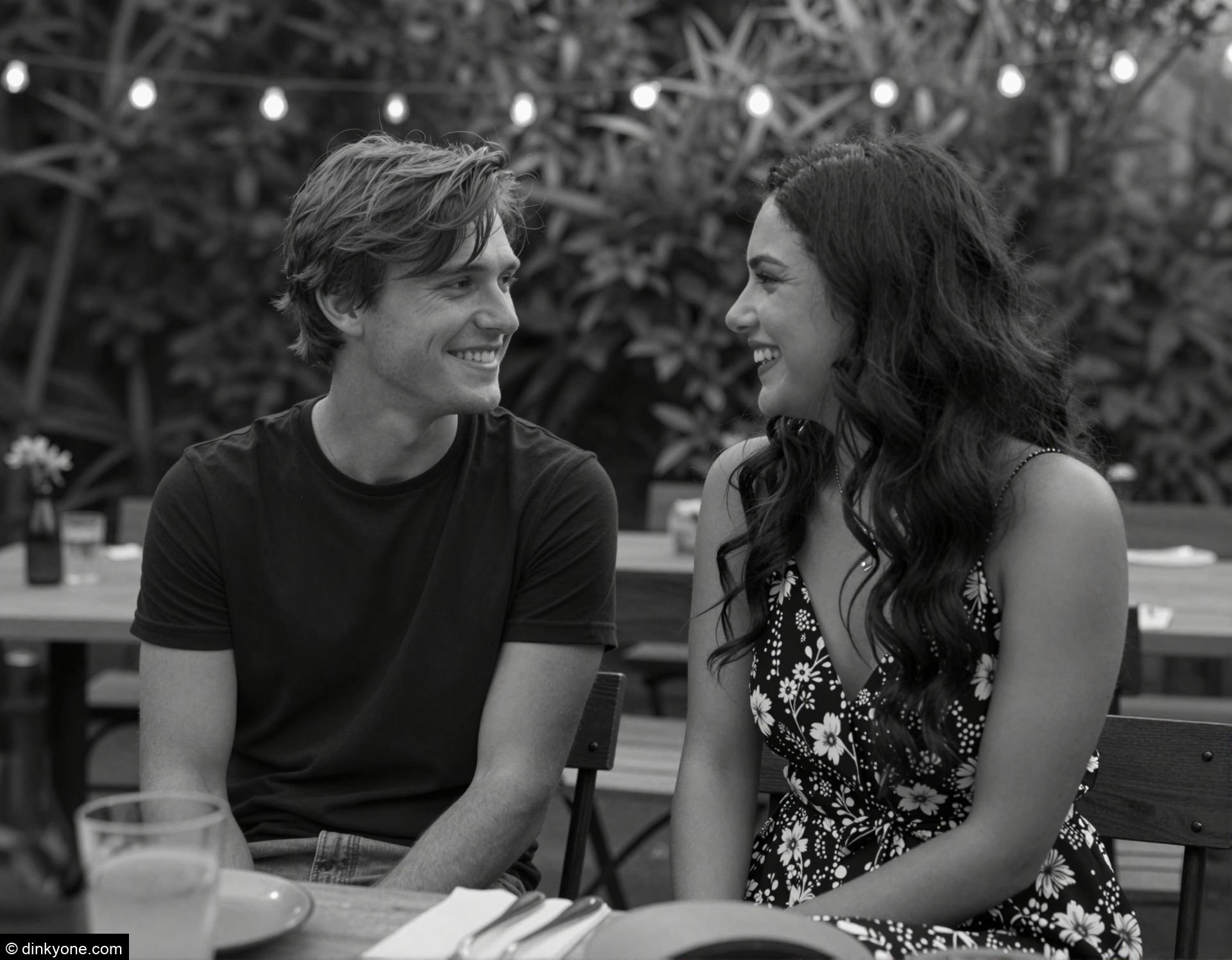 A young couple at a private garden restaurant with fairy lights.